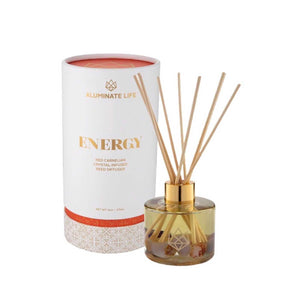 Energy Reed Diffuser | Aluminate Life featuring a glass container with gold accents and reed sticks, alongside a white and orange decorative packaging for a wellness and body care ambiance.