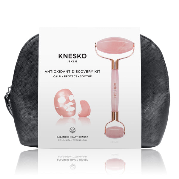 Rose Quartz Antioxidant Discovery Kit | Knesko featuring a rose quartz facial roller and a black travel pouch for skincare and wellness recovery tools.