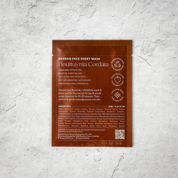 Packaging of Korean Sheet Mask - Make Today Amazing | Lucky Owl in brown with detailed text about ingredients and usage instructions on a textured light gray surface.
