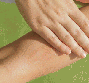 Close-up of a hand applying Lustre Drench® Instant Glow Dry Oil | Farmhouse Fresh, illustrating hydrated, glowing skin with a subtle shimmer for a radiant body care effect.