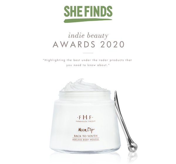 Glass jar of Moon Dip Back To Youth Ageless Body Mousse | Farmhouse Fresh with a small silver spatula, featured in She Finds Indie Beauty Awards 2020 with creamy white body care mousse visible.