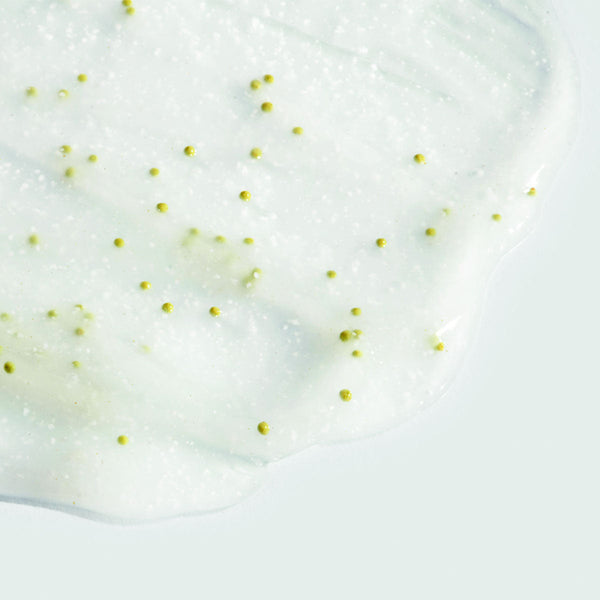 Close-up of clear gel with small green beads spread on a light surface, showcasing texture of ORMEDIC balancing gel polisher | IMAGE Skincare for skincare and wellness care.