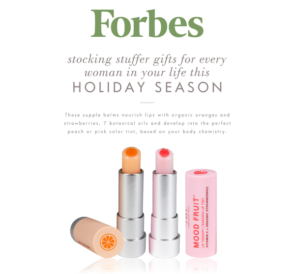 Forbes holiday gift guide featuring Strawberry Mood Fruit™ Lip Therapy | Farmhouse Fresh, showing two lip balms with botanical fruit designs and soft peach and pink tints.
