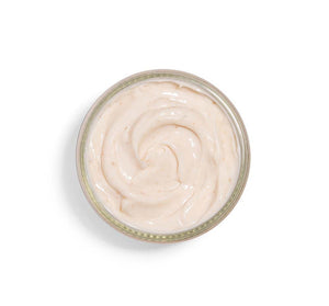 Top view of creamy textured skincare mask in a clear jar, featuring Pudding Apeel® Tapioca + Rice Active Fruit Glycolic Mask | FarmHouse Fresh for gentle exfoliation and glowing skin.
