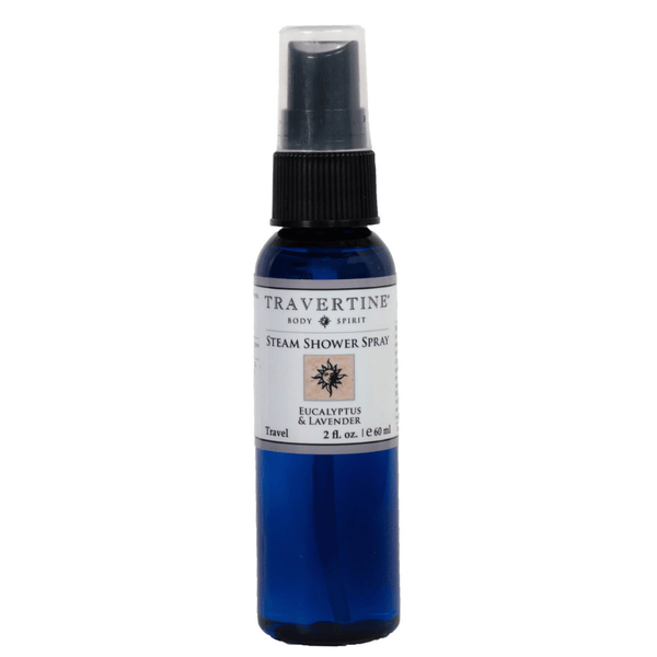 Blue travel-sized spray bottle labeled "Eucalyptus + Lavender Steam Shower Spray | Travertine Spa" designed for enhancing wellness and body care with a refreshing scent.