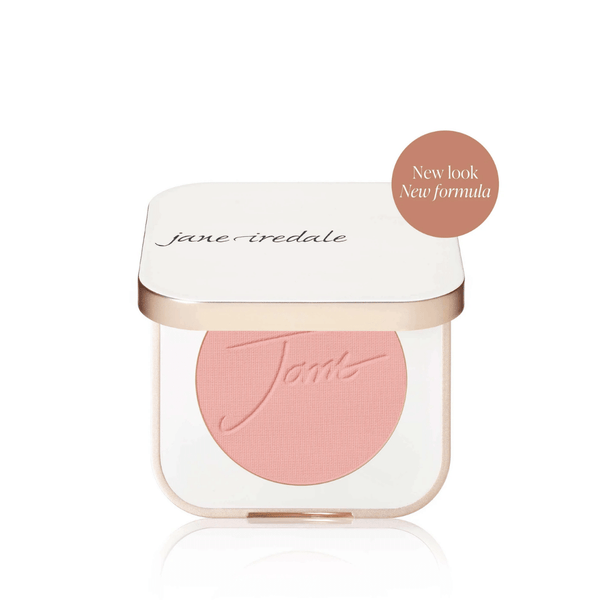 Compact powder blush in soft pink shade with embossed script, housed in a white and gold case labeled Purepressed Blush | Jane Iredale featuring new look and formula badge.