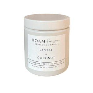 Minimalist white jar candle labeled Santal + Coconut with a clean, modern design, featuring the text "Santal + Coconut 10 oz Candle | ROAM Homegrown" on the label.