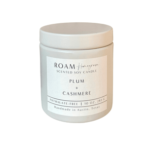 Plum + Cashmere 10 oz Candle | ROAM Homegrown in a white ceramic container with minimalist label, handmade soy candle designed for a cozy and elegant ambiance.