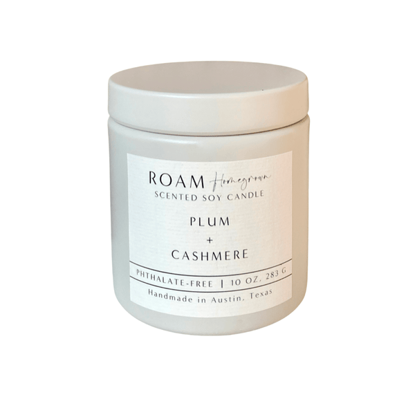 Plum + Cashmere 10 oz Candle | ROAM Homegrown in a white ceramic container with minimalist label, handmade soy candle designed for a cozy and elegant ambiance.