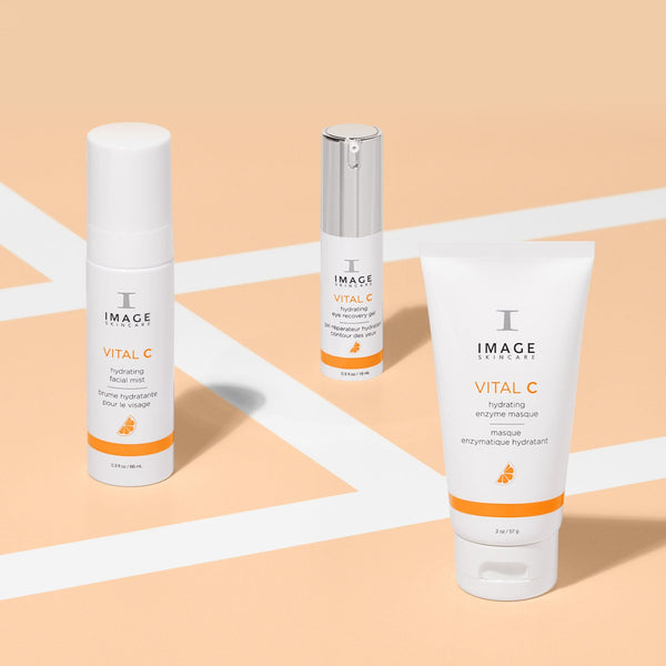 Three IMAGE Skincare products from the Vital C line including hydrating eye recovery gel | IMAGE Skincare, displayed on a peach-colored background for skincare and wellness.