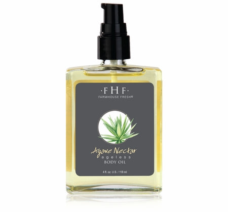 Clear glass bottle with black pump containing yellow body oil, labeled Agave Nectar Ageless Body Oil | Farmhouse Fresh with an agave plant illustration, for skincare and body care.