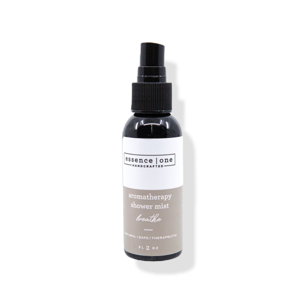 Bottle of Aromatherapy Shower Mist | Essence One with a spray nozzle, featuring a minimalist white and beige label promoting natural and therapeutic body care for wellness and relaxation.