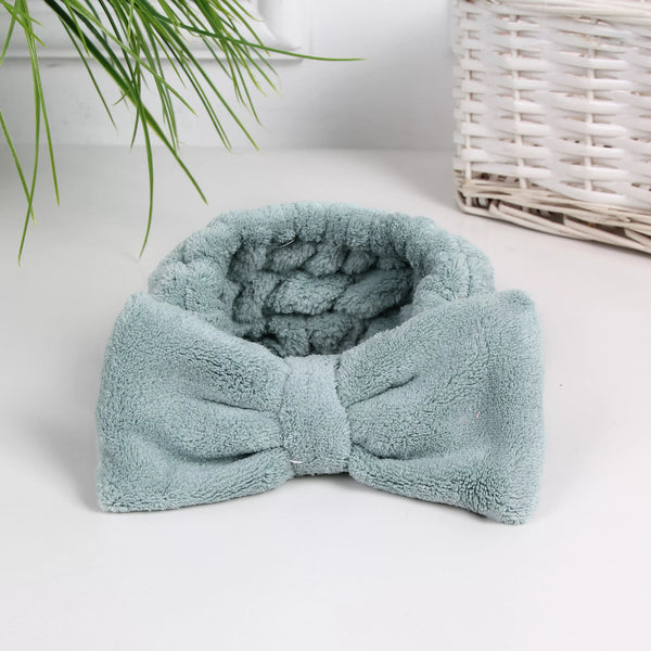 Soft green spa headband with a large bow design, perfect for skincare and wellness routines, Luxe Spa Headbands | Lucky Owl style.