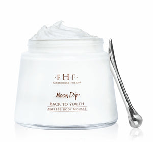 Jar of Moon Dip Back To Youth Ageless Body Mousse | Farmhouse Fresh with a whipped white mousse texture and a small metal spatula for skincare and body care application.