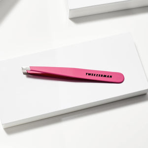 Slant Tweezer | Tweezerman in bright pink with precise angled tips, ideal for skincare and body care grooming routines.