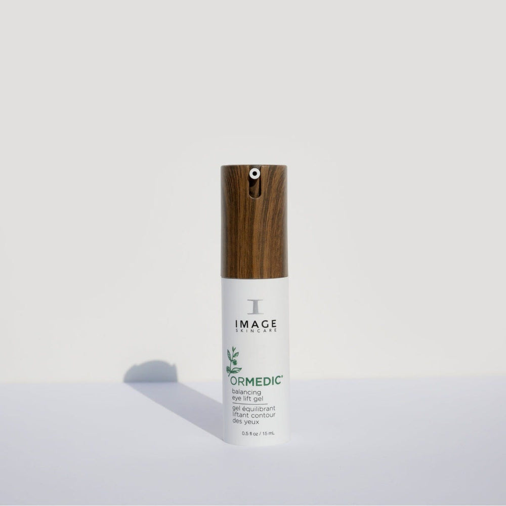 ORMEDIC balancing eye lift gel | IMAGE Skincare in a white bottle with a wood-textured pump top, designed for skincare targeting eye area hydration and lifting.