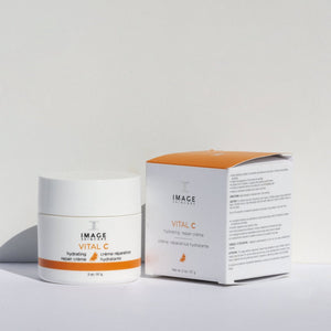 VITAL C hydrating repair crème | IMAGE Skincare in a white jar with orange accents next to its matching box, showcasing skincare packaging for hydration and repair.