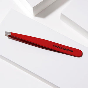 Slant Tweezer | Tweezerman in red with precision tips for expert eyebrow shaping and skincare grooming, designed for comfortable and accurate hair removal.